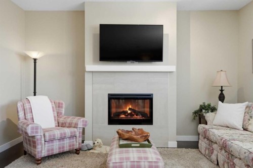 26 Cranbrook Villas Se, Calgary, AB - Indoor Photo Showing Living Room With Fireplace