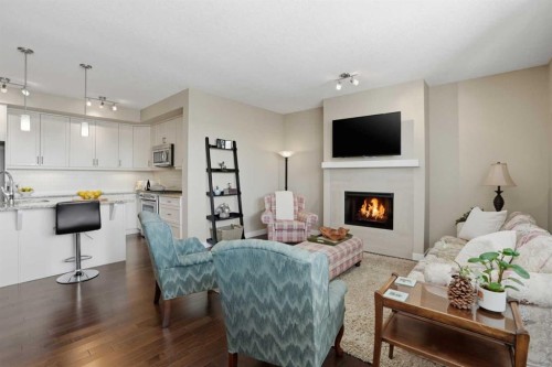 26 Cranbrook Villas Se, Calgary, AB - Indoor Photo Showing Living Room With Fireplace