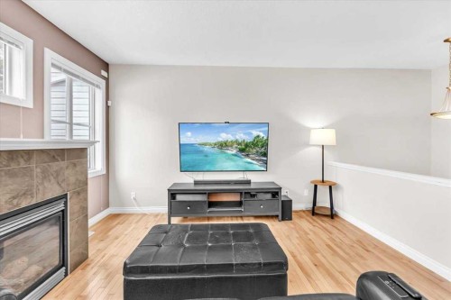 133 Tucker Circle, Okotoks, AB - Indoor Photo Showing Living Room With Fireplace