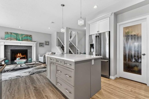 142 Masters Common Se, Calgary, AB - Indoor Photo Showing Kitchen With Fireplace With Stainless Steel Kitchen With Upgraded Kitchen