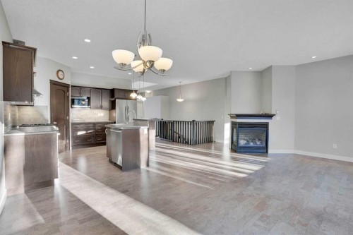 27-925 Imperial Drive, Diamond Valley, AB - Indoor Photo Showing Kitchen With Fireplace