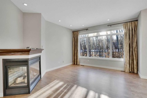 27-925 Imperial Drive, Diamond Valley, AB - Indoor Photo Showing Other Room With Fireplace