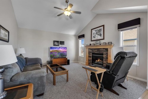 23 Evansbrooke Manor Nw, Calgary, AB - Indoor Photo Showing Living Room With Fireplace