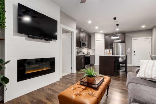 312-10 Walgrove Walk Se, Calgary, AB - Indoor Photo Showing Living Room With Fireplace