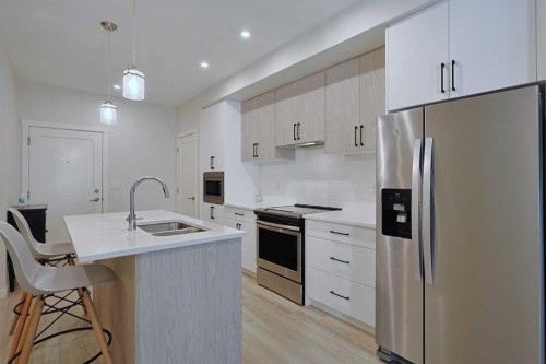 403-138 Sage Valley Common Nw, Calgary, AB - Indoor Photo Showing Kitchen With Stainless Steel Kitchen With Double Sink With Upgraded Kitchen