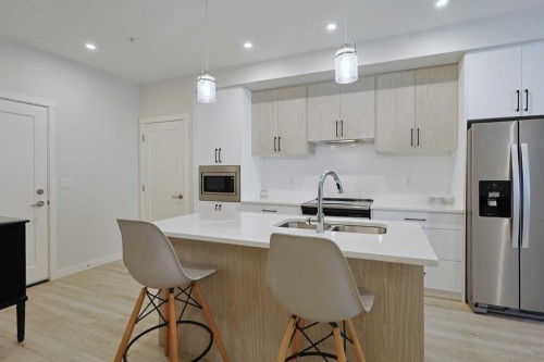 403-138 Sage Valley Common Nw, Calgary, AB - Indoor Photo Showing Kitchen With Stainless Steel Kitchen With Double Sink With Upgraded Kitchen