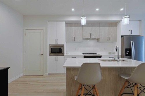 403-138 Sage Valley Common Nw, Calgary, AB - Indoor Photo Showing Kitchen With Stainless Steel Kitchen With Double Sink With Upgraded Kitchen