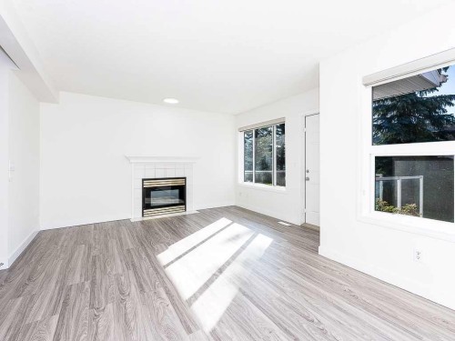 100 Catalina Circle Ne, Calgary, AB - Indoor Photo Showing Living Room With Fireplace