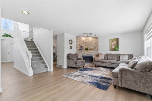 39 Arbour Ridge Mews Nw, Calgary, AB - Indoor Photo Showing Living Room With Fireplace