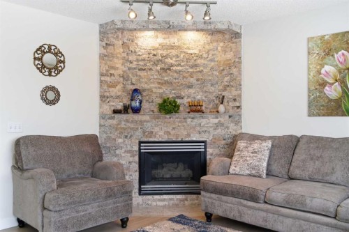 39 Arbour Ridge Mews Nw, Calgary, AB - Indoor Photo Showing Living Room With Fireplace