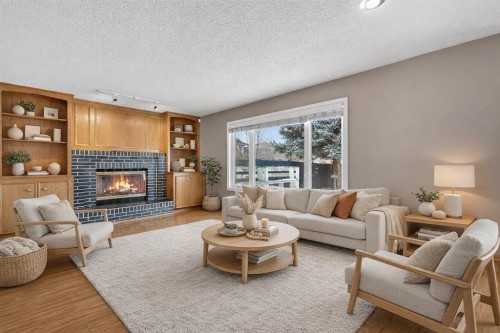1208 Sunvista Way Se, Calgary, AB - Indoor Photo Showing Living Room With Fireplace