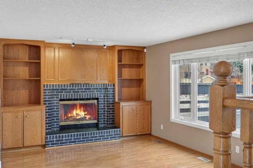 1208 Sunvista Way Se, Calgary, AB - Indoor With Fireplace