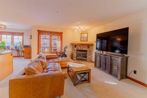313-170 Crossbow Place, Canmore, AB - Indoor Photo Showing Living Room With Fireplace