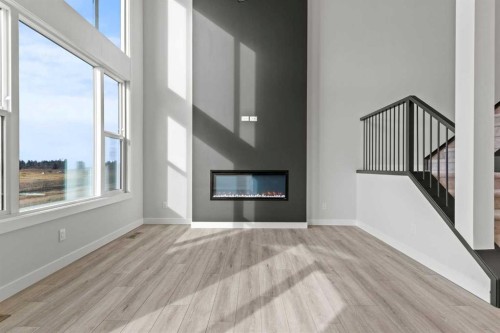 302 Kinniburgh Loop, Chestermere, AB - Indoor Photo Showing Living Room With Fireplace