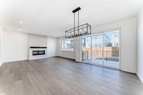 196 Starling Place Nw, Calgary, AB - Indoor Photo Showing Other Room With Fireplace