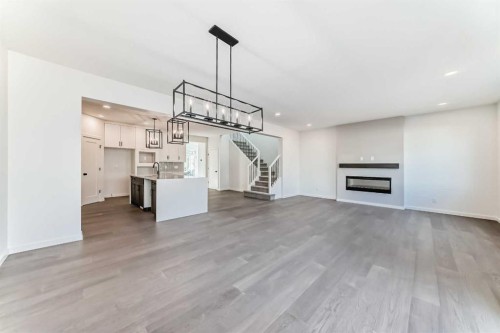 196 Starling Place Nw, Calgary, AB - Indoor Photo Showing Other Room With Fireplace