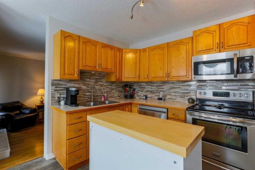 1118 Maple Avenue, Crossfield, AB - Indoor Photo Showing Kitchen With Double Sink