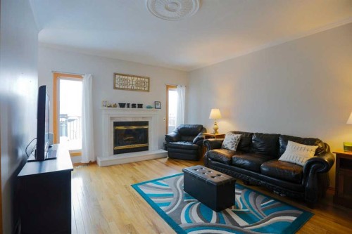 1118 Maple Avenue, Crossfield, AB - Indoor Photo Showing Living Room With Fireplace