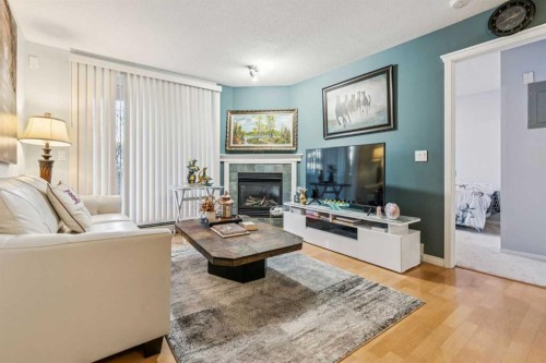 105-15320 Bannister Road Se, Calgary, AB - Indoor Photo Showing Living Room With Fireplace