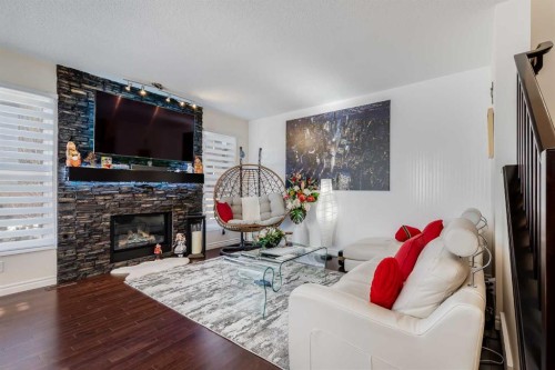 87 Evanswood Circle Nw, Calgary, AB - Indoor Photo Showing Living Room With Fireplace