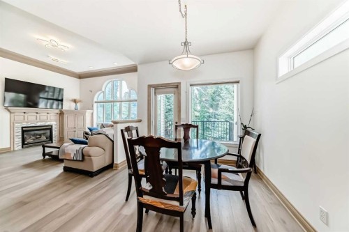 29 Simcoe Gate Sw, Calgary, AB - Indoor Photo Showing Dining Room With Fireplace