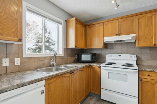 42 Hidden Hills Way Nw, Calgary, AB - Indoor Photo Showing Kitchen With Double Sink