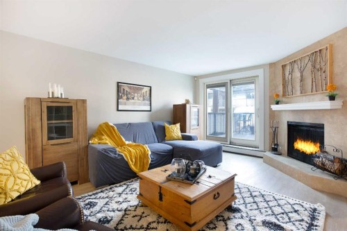 102-350 4 Avenue Ne, Calgary, AB - Indoor Photo Showing Living Room With Fireplace