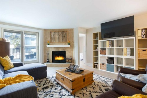 102-350 4 Avenue Ne, Calgary, AB - Indoor Photo Showing Living Room With Fireplace