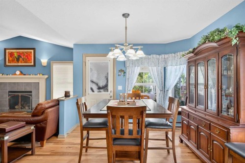 125 Copeland Close, Langdon, AB - Indoor Photo Showing Dining Room With Fireplace