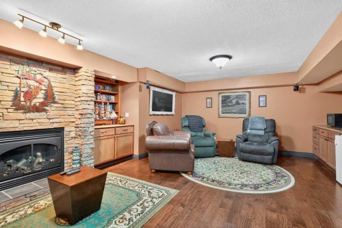 125 Copeland Close, Langdon, AB - Indoor Photo Showing Living Room With Fireplace