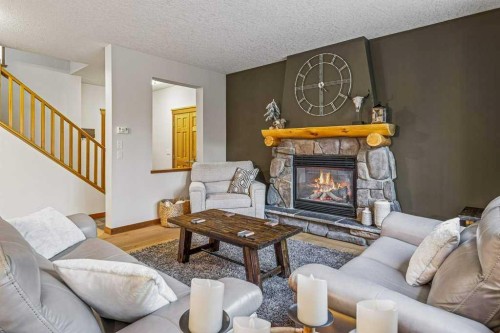 215 Miskow Close, Canmore, AB - Indoor Photo Showing Living Room With Fireplace
