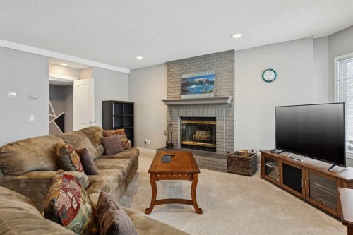 231 Scimitar Bay Nw, Calgary, AB - Indoor Photo Showing Living Room With Fireplace