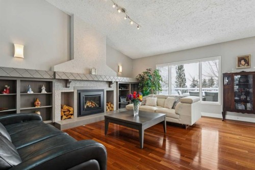 231 Scimitar Bay Nw, Calgary, AB - Indoor Photo Showing Living Room With Fireplace