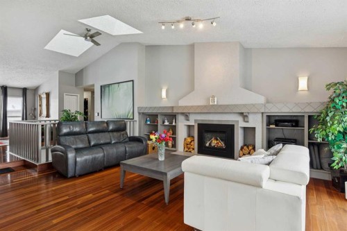 231 Scimitar Bay Nw, Calgary, AB - Indoor Photo Showing Living Room With Fireplace