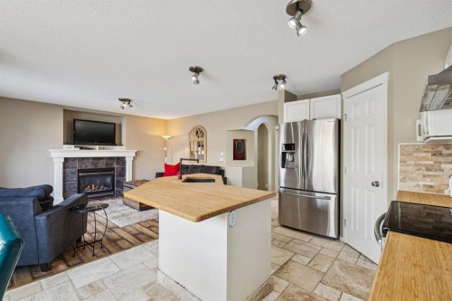 40 Shannon Gardens Sw, Calgary, AB - Indoor Photo Showing Kitchen With Fireplace