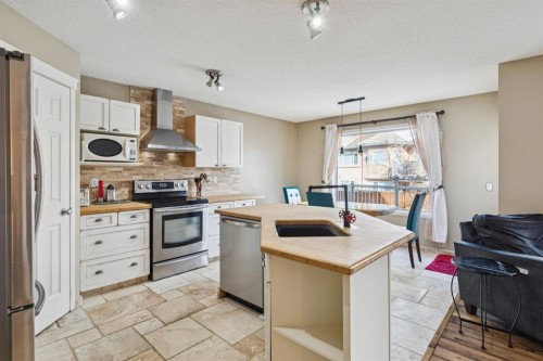 40 Shannon Gardens Sw, Calgary, AB - Indoor Photo Showing Kitchen With Stainless Steel Kitchen With Double Sink
