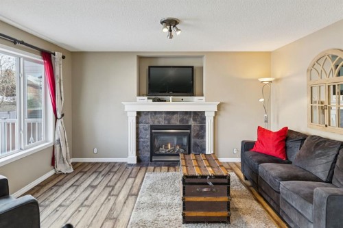 40 Shannon Gardens Sw, Calgary, AB - Indoor Photo Showing Living Room With Fireplace