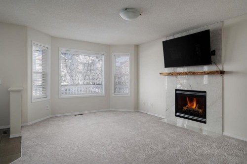 641 Evermeadow Road Sw, Calgary, AB - Indoor Photo Showing Living Room With Fireplace