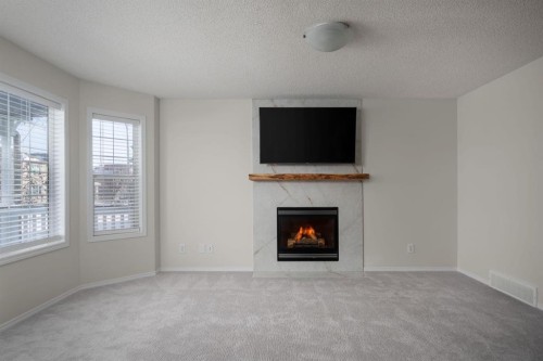 641 Evermeadow Road Sw, Calgary, AB - Indoor Photo Showing Living Room With Fireplace