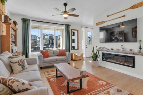 374 Sundown Road, Cochrane, AB - Indoor Photo Showing Living Room With Fireplace