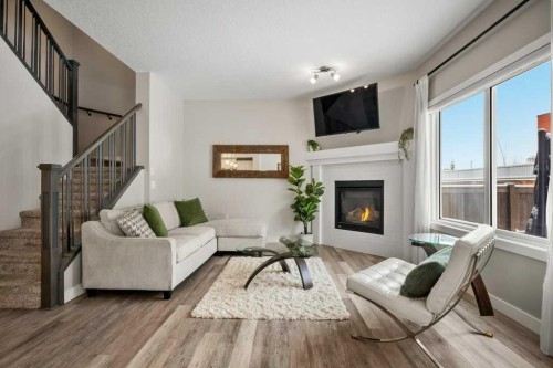 183 Kinniburgh Road, Chestermere, AB - Indoor Photo Showing Living Room With Fireplace