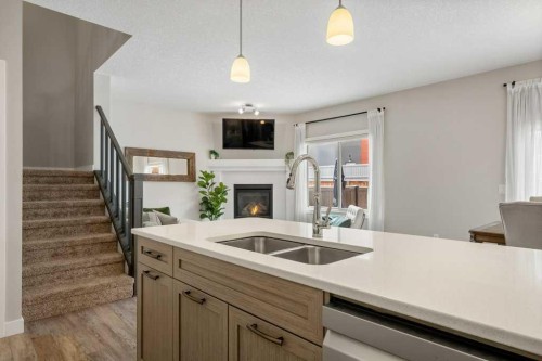 183 Kinniburgh Road, Chestermere, AB - Indoor Photo Showing Kitchen With Fireplace With Double Sink