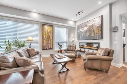 302-105 Lebel Crescent Nw, Calgary, AB - Indoor Photo Showing Living Room With Fireplace
