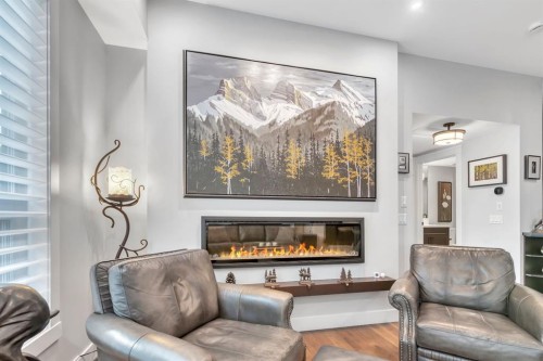 302-105 Lebel Crescent Nw, Calgary, AB - Indoor Photo Showing Living Room With Fireplace