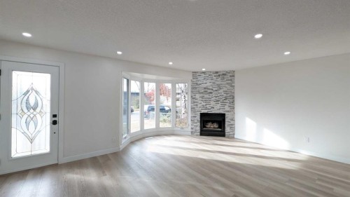 4 Harvey Place Sw, Calgary, AB - Indoor Photo Showing Living Room With Fireplace