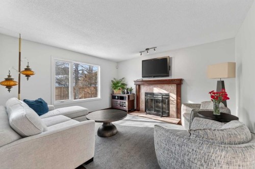 52 Riverwood Circle Se, Calgary, AB - Indoor Photo Showing Living Room With Fireplace