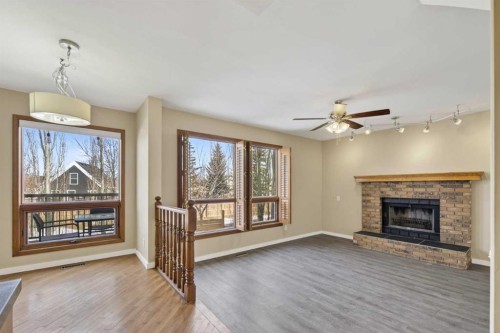 84 Rivergreen Crescent Se, Calgary, AB - Indoor Photo Showing Living Room With Fireplace