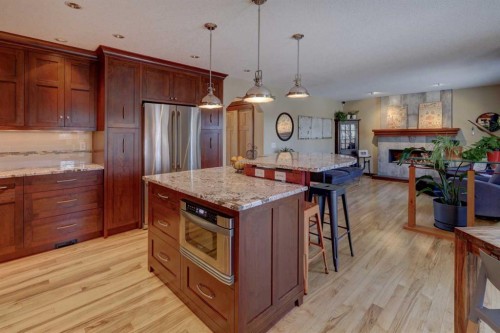 66 Scimitar Point Nw, Calgary, AB - Indoor Photo Showing Kitchen With Fireplace