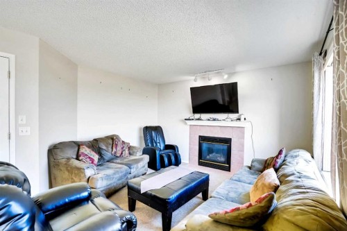 69 Coral Springs Park Ne, Calgary, AB - Indoor Photo Showing Living Room With Fireplace