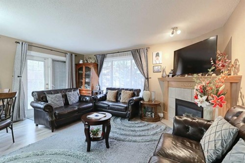 501 Coral Cove Ne, Calgary, AB - Indoor Photo Showing Living Room With Fireplace